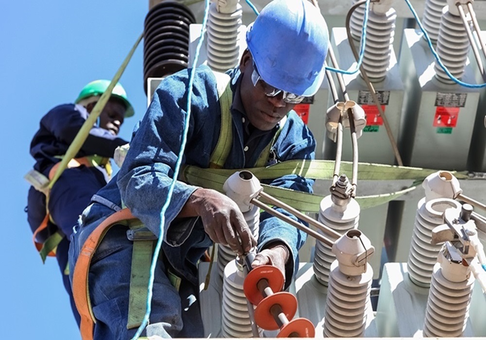Johannesburg, South Africa, 04/11/2012, Electricians working on high voltage power lines. Highly skilled workmen servicing the electricity grid